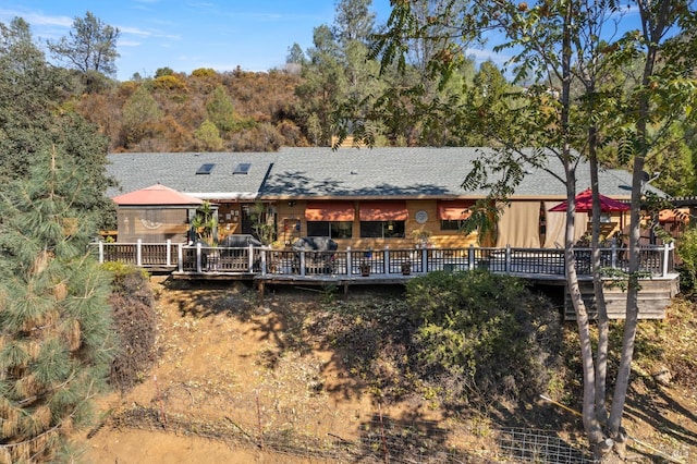 back of house with a wooden deck