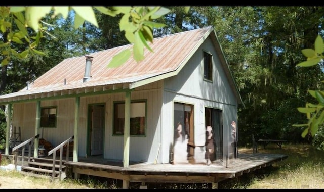 back of house with a wooden deck