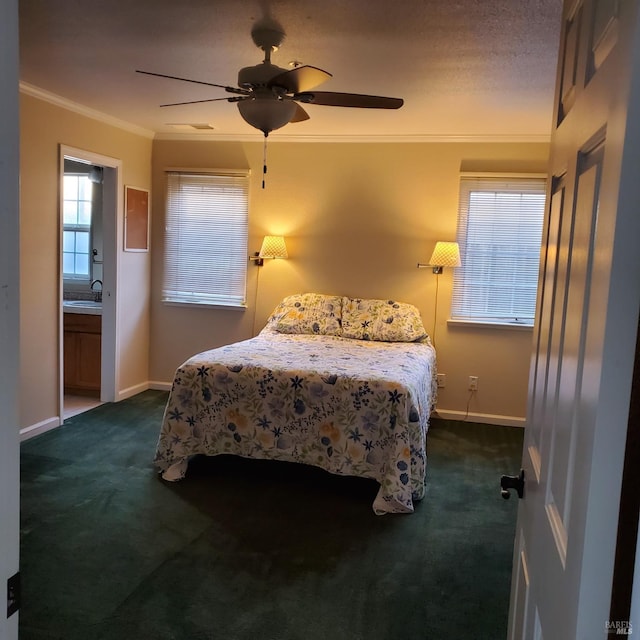 bedroom featuring dark colored carpet, sink, ceiling fan, ornamental molding, and connected bathroom