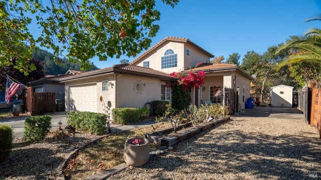 view of front of home featuring a storage unit and a garage