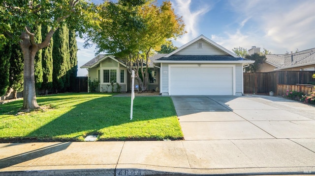 view of front of home featuring a garage and a front yard