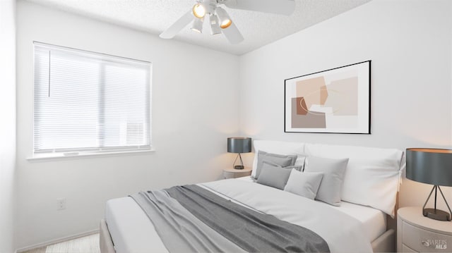 bedroom featuring ceiling fan and a textured ceiling