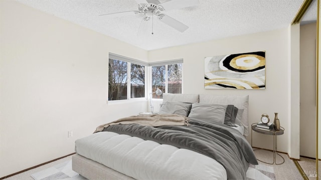 bedroom with baseboards, carpet, a ceiling fan, and a textured ceiling