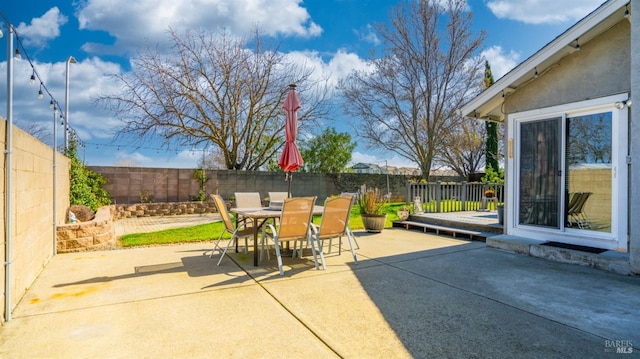 view of patio with a fenced backyard and outdoor dining space