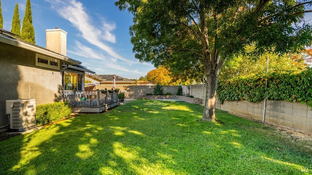 view of yard featuring central AC unit and a wooden deck