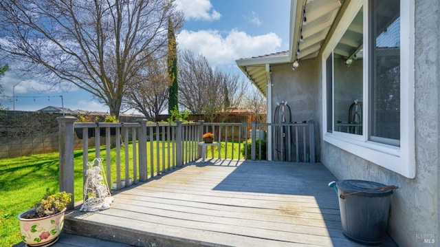 deck with a fenced backyard and a lawn