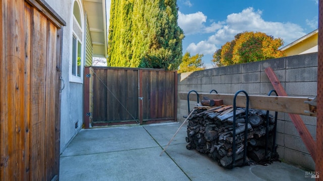 view of patio with a gate and fence