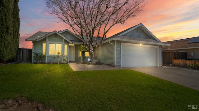 single story home featuring driveway, a yard, an attached garage, and fence