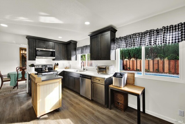 kitchen with dark brown cabinetry, sink, and stainless steel appliances