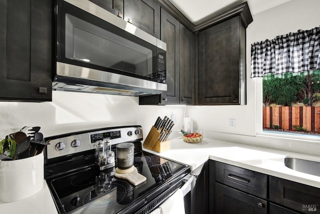 kitchen with dark wood-type flooring, stainless steel fridge, and dark brown cabinetry