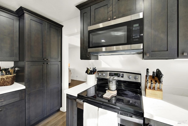 kitchen featuring stainless steel appliances and dark hardwood / wood-style floors