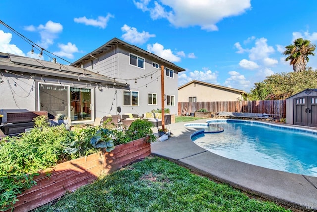 view of swimming pool with a patio and a shed