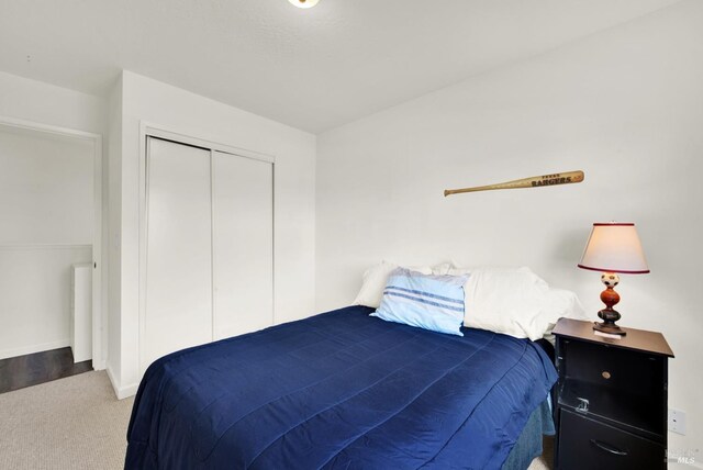 unfurnished bedroom featuring light colored carpet and a closet