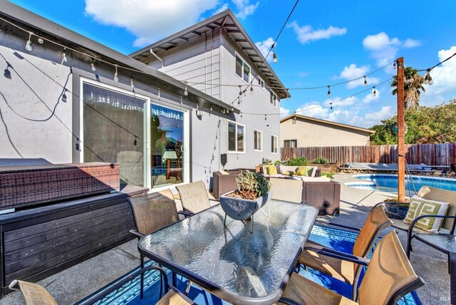 view of pool featuring an in ground hot tub, outdoor lounge area, and a patio