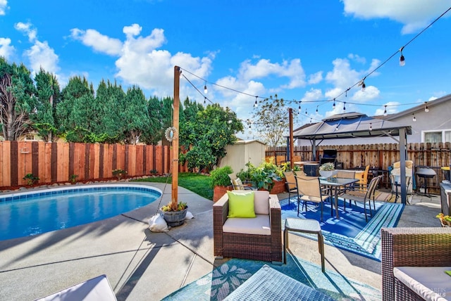 view of pool with a patio and a shed