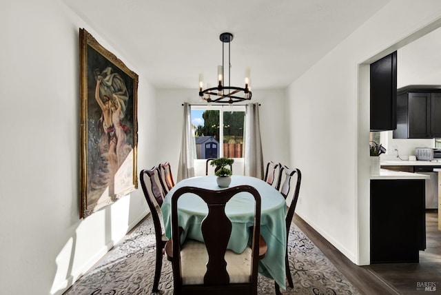 living room with an inviting chandelier and dark wood-type flooring