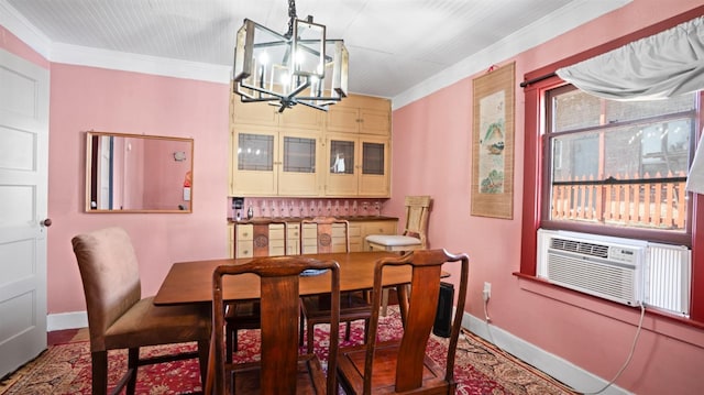 dining area featuring crown molding, cooling unit, and a chandelier