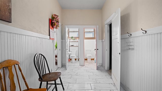 14090 Winnie St, Walnut Grove, CA 95690 - hallway with light marble finish floors and a wainscoted wall