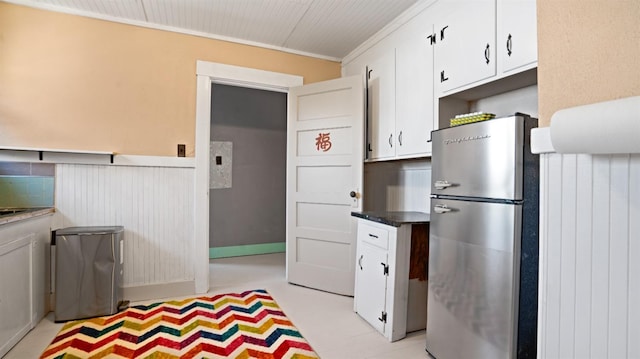 14090 Winnie St, Walnut Grove, CA 95690 - kitchen with freestanding refrigerator, a wainscoted wall, white cabinetry, and ornamental molding