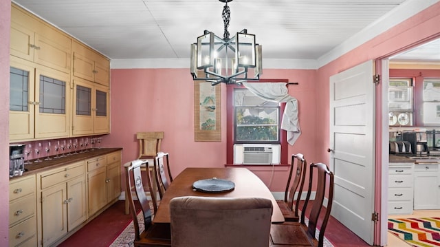 dining area with ornamental molding, plenty of natural light, cooling unit, and a notable chandelier