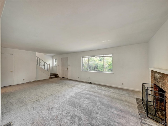 unfurnished living room featuring carpet floors and a fireplace