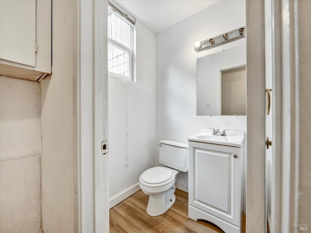 bathroom with vanity, hardwood / wood-style floors, and toilet