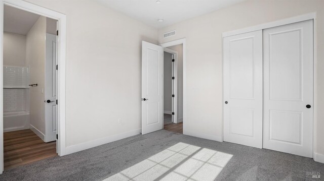 unfurnished bedroom with carpet floors and a closet