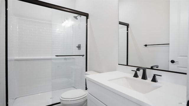 bathroom with vanity, toilet, and an enclosed shower