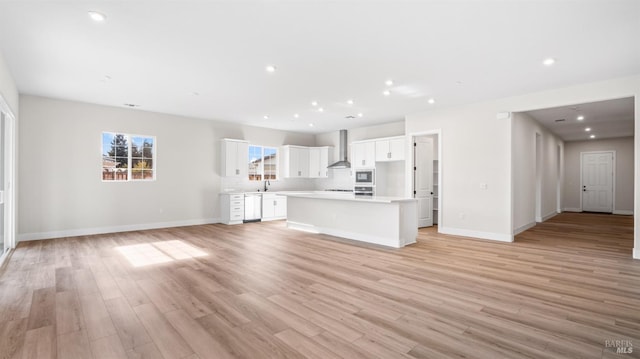 unfurnished living room with sink and light wood-type flooring