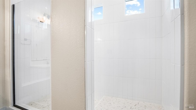 bathroom with a tile shower