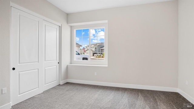 unfurnished bedroom with a closet and carpet floors