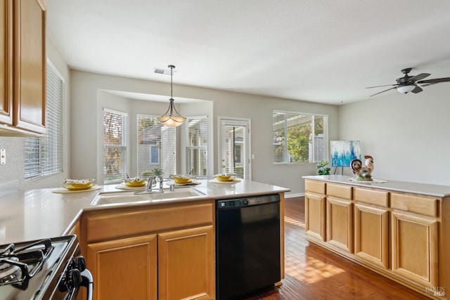 kitchen featuring dishwasher, hanging light fixtures, wood-type flooring, sink, and stainless steel gas range oven