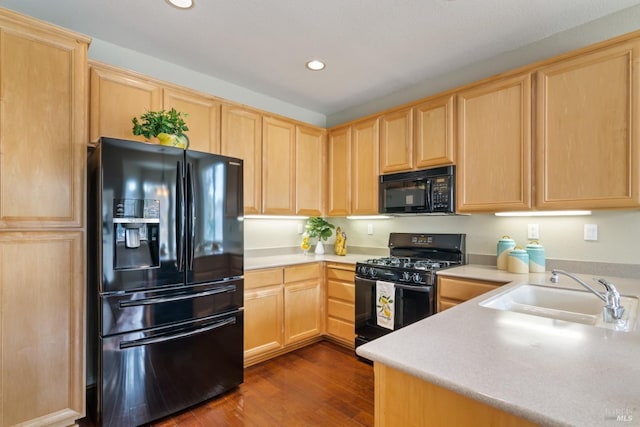 kitchen featuring black appliances, sink, light brown cabinetry, and dark hardwood / wood-style flooring