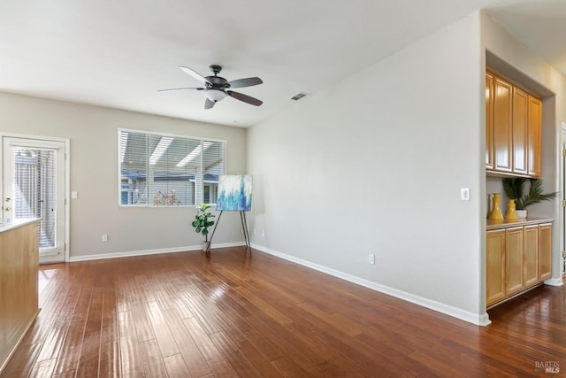 interior space featuring dark wood-type flooring and ceiling fan