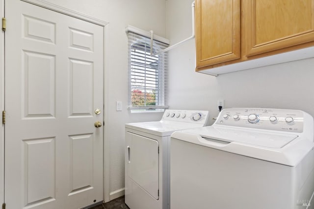 laundry area with independent washer and dryer and cabinets