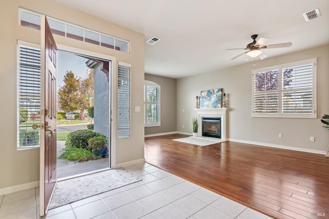 foyer entrance featuring a wealth of natural light, light hardwood / wood-style flooring, and ceiling fan