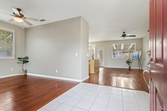 unfurnished room with light hardwood / wood-style flooring and ceiling fan