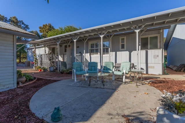 back of property with a patio