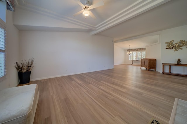 unfurnished living room featuring ceiling fan with notable chandelier, light hardwood / wood-style flooring, and beamed ceiling