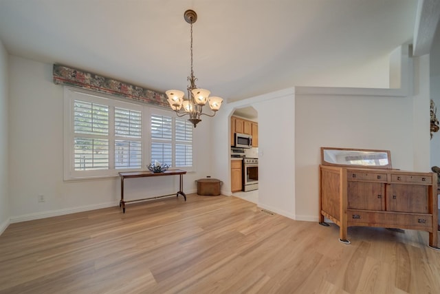 dining area featuring a chandelier and light hardwood / wood-style flooring