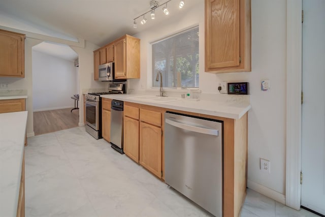 kitchen featuring sink, light brown cabinets, and appliances with stainless steel finishes