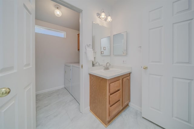 bathroom with vanity and washer and dryer