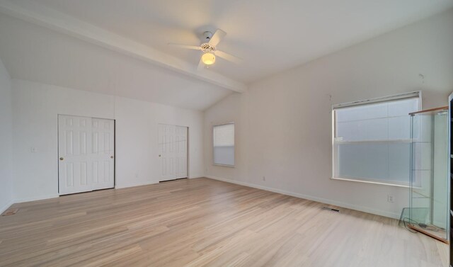 unfurnished room with vaulted ceiling with beams, light hardwood / wood-style flooring, and ceiling fan