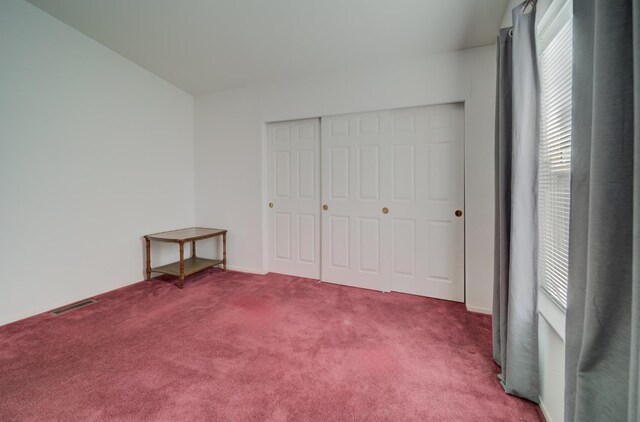 unfurnished bedroom with carpet flooring and a closet