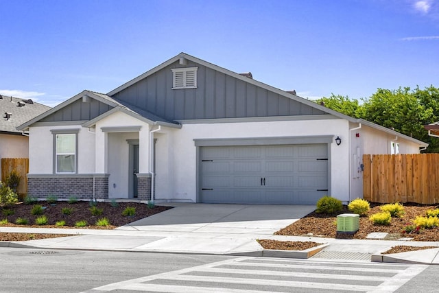 6606 Jackpot Pl, Riverbank, CA 95367 - view of front of home with board and batten siding, an attached garage, concrete driveway, brick siding, and stucco siding