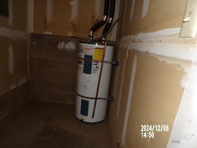 utility room featuring electric water heater