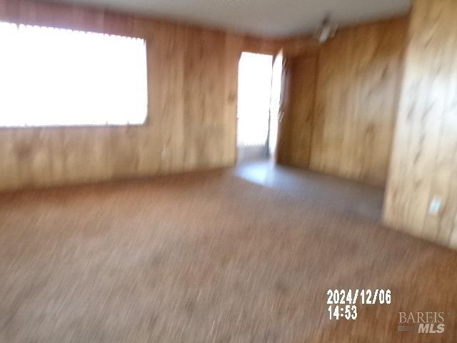 empty room featuring wooden walls