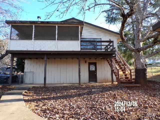 back of property featuring a deck