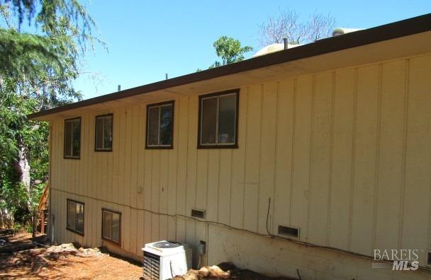 view of side of home featuring central air condition unit