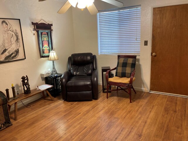 sitting room with wood-type flooring and ceiling fan